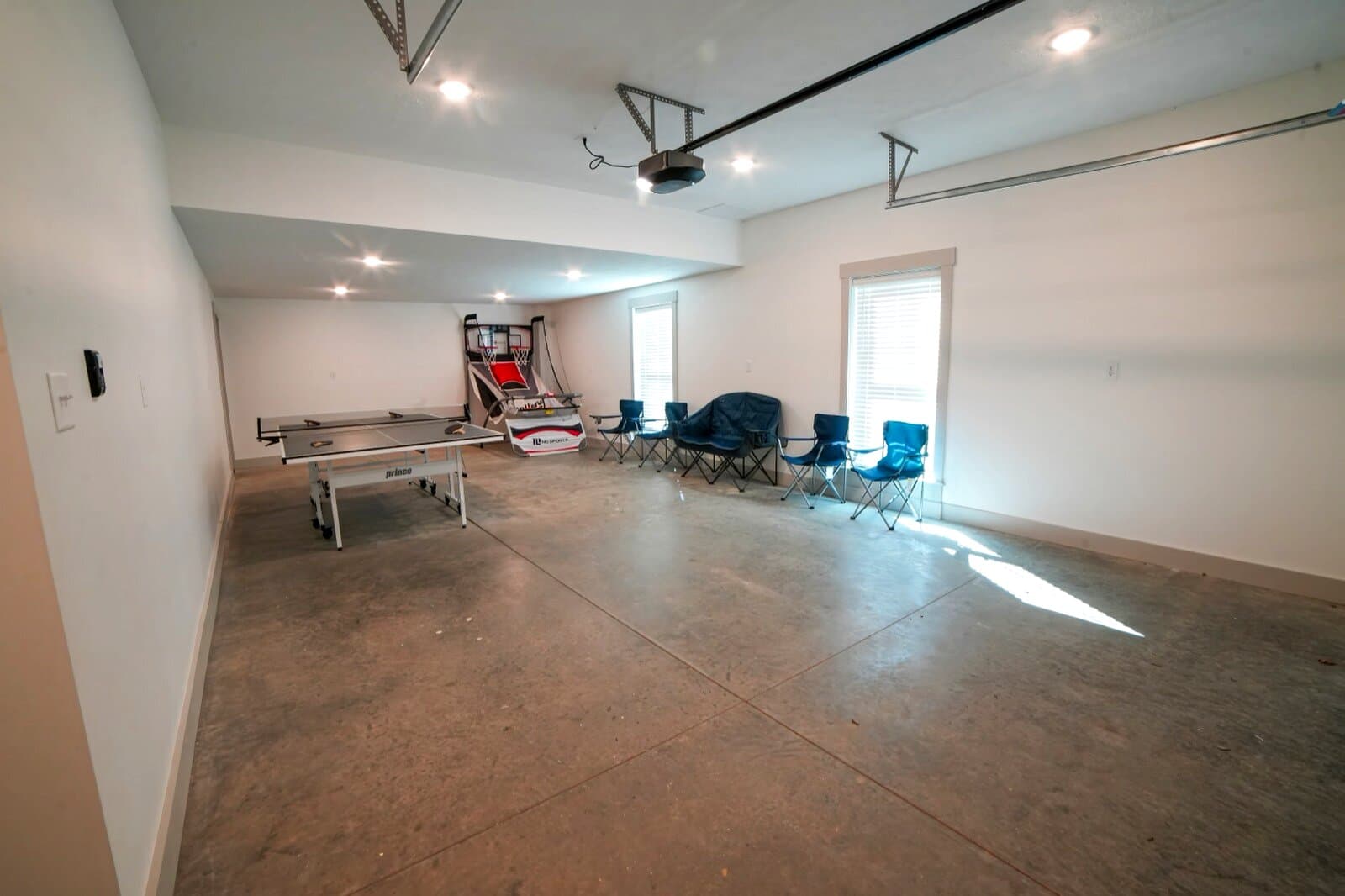 Game room with ping pong, Pop-A-Shot, and arcade chairs